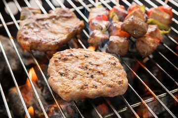 Assorted delicious grilled meat over the coals on a barbecue