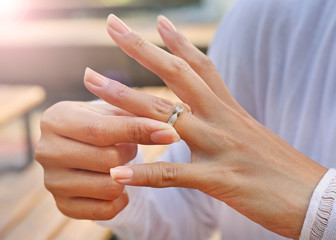 Woman is taking off the wedding ring