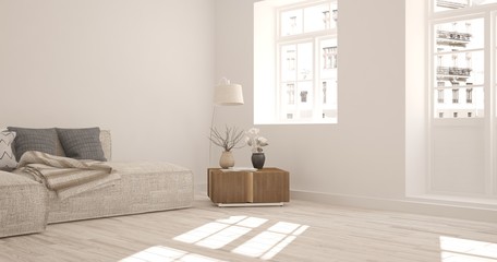 White room with sofa and urban landscape in window. Scandinavian interior design