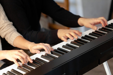 Obraz premium Closeup of hands playing piano. Music and hobby concept