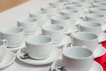 coffee or tea cups in row on table
