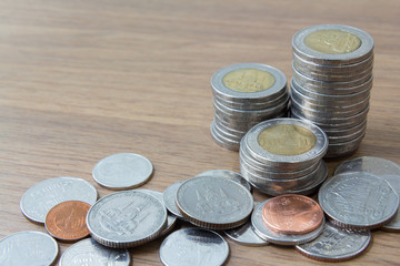 Thai money coins tower on wooden table