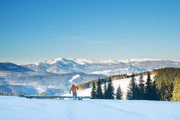 not recognizable person in the mountains running through the snow