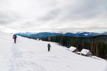 Fototapeta na wymiar two backpackers in snowy mountains