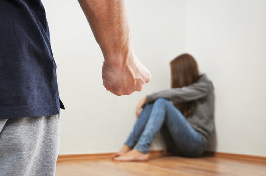 Fist of adult man prepared to hurt the child because of domestic violence