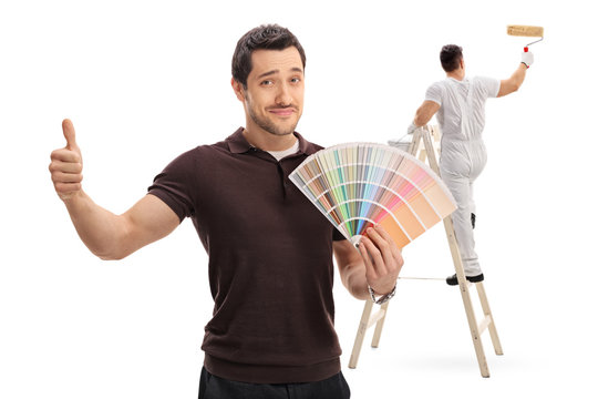 Man with a color swatch and painter on ladder