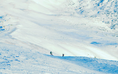 skier and snowboarder freeride in mountains