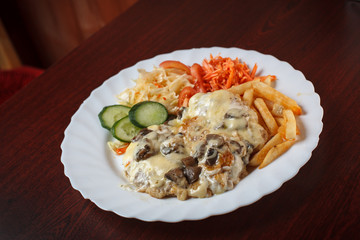 Beef steak with cheese, mushrooms and vegetables