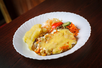 Steak with cheese vegetables and mashed potatos