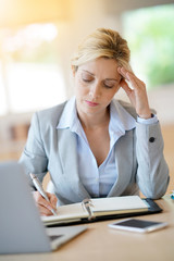 Businesswoman working in office on agenda