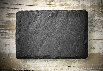 black slate board on aged wood