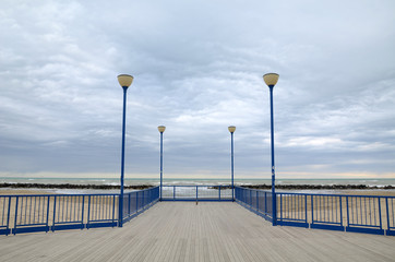 a dock near the sea with a wooden parquet