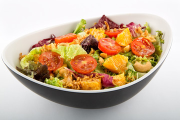 Lettuce salad tomato cheese and nuts