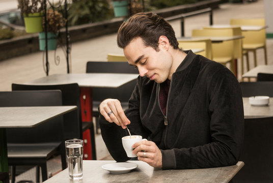 one young man looking at coffee cup