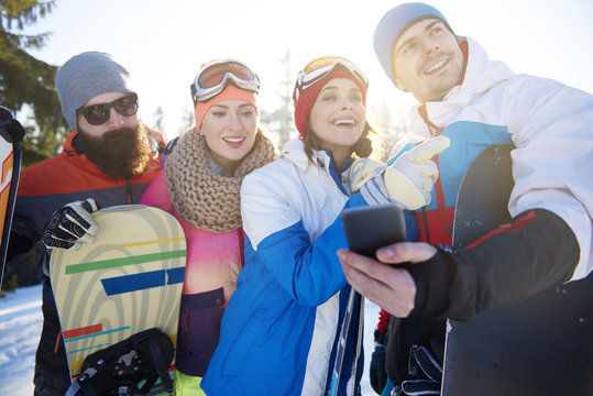 Friends with cell phone on the ski trip