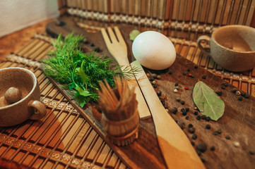 Egg herbs spices and other ingredients for the preparation of fried eggs lay on the wooden Boards. breakfast concept