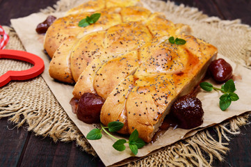 Sweet pastry: roll with strawberry jam. Close up