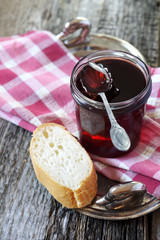 Red jam and slice of baguette