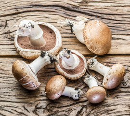 Champignon mushrooms on the wooden table.
