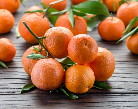Ripe tangerines on wooden table.