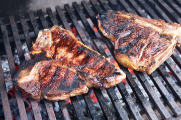 Roasted T-bone steak on barbeque.