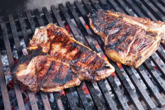 Roasted T-bone steak on barbeque.