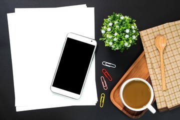 Blank paper and blank screen smartphone, coffee on black table background / can be used for your text or artwork / top view - Powered by Adobe