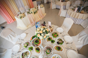 Beautiful flowers in the restaurant on the table. Wedding Banquet. Elegant dinner table.
