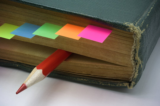 Aging Book With Bookmark And Red Pencil For Marks