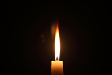 Lighting candles on a black background.