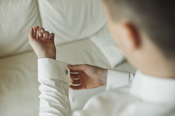 Fototapeta na wymiar close up of a hand man how wears white shirt and cufflink