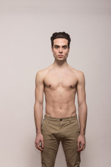 young man model shirtless body posing pants