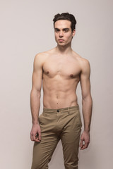 young man model shirtless body posing pants