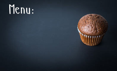 muffin or cupcake on a black background and text menu