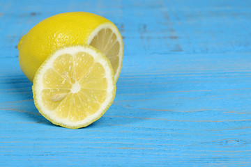 sliced lemon on blue wood