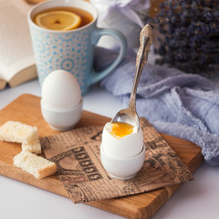 freshly boiled white egg on wooden board. Healthy fitness breakfast