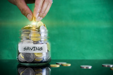 Preparation for future and financial concept. Coins in glass jar with SAVING label. Malaysia coins.