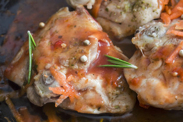 cooking delicious juicy legs of chicken in tomato sauce