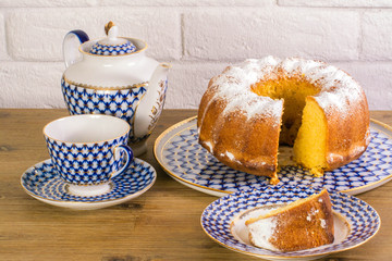 Exposition of apple pie cup of tea and kettle on wooden table and white brick background, Vintage Russian porcelain teacup and kettle.