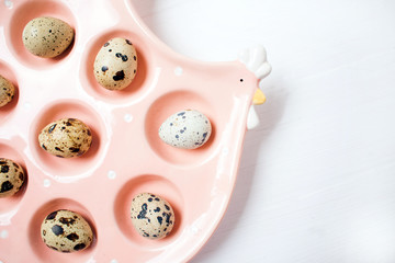Ceramic chicken with Quail eggs on white background. Concept of Easter celebration. Place for text