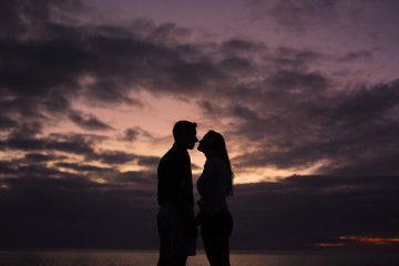 Fototapeta premium Couple in love silhouette during sunset - touching noses
