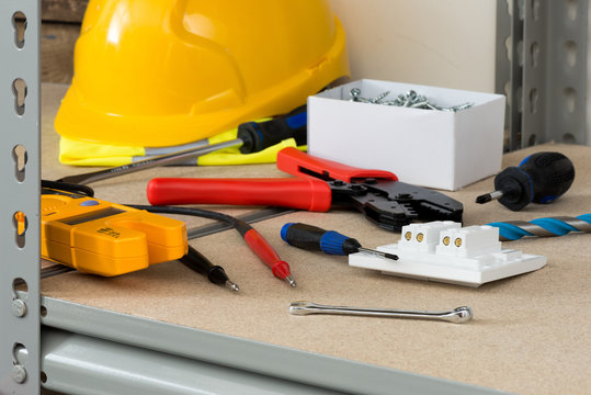 Electrical Tools and Supplies on Cork-Covered Shelving