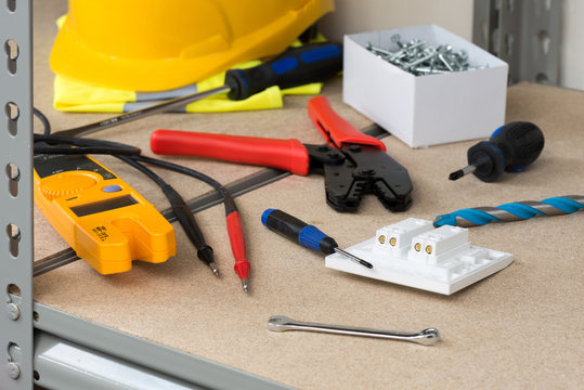 Electrician's Gear and Equipment on Cork-Covered Shelving