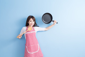 housewife take wok and spoon