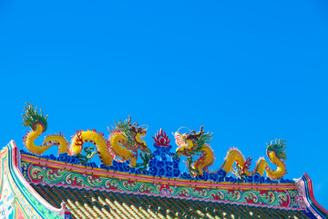 Chinese style dragon statue on blue sky background.