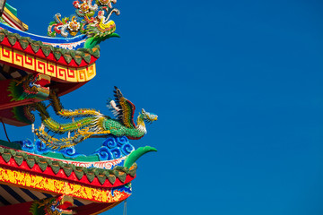 Chinese style dragon statue on blue sky background.