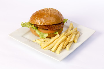 Cheeseburger and fries on restaurant table