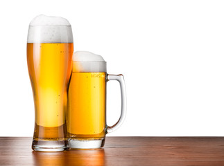 Two glasses of beer on a wooden table