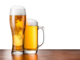 Two glasses of beer on a wooden table