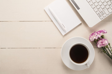  Office table with cup of coffee and flowers 